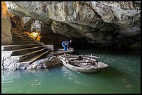 Man readyning a boat inside cave, Trang An. Ninh Binh,  Vietnam ( color)