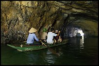 Boat rowed inside grotto passage, Trang An. Ninh Binh,  Vietnam (color)