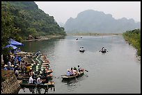 Groups leaving wharf on boats, Trang An. Ninh Binh,  Vietnam ( color)