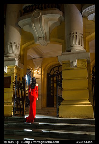 Woman in evening gown entering opera house. Hanoi, Vietnam