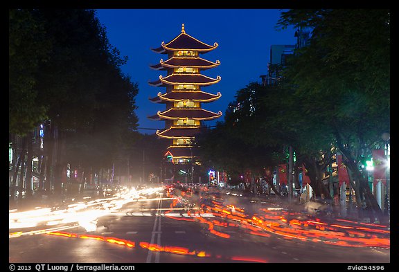 Traffic at night and Quoc Tu Pagoda, district 10. Ho Chi Minh City, Vietnam