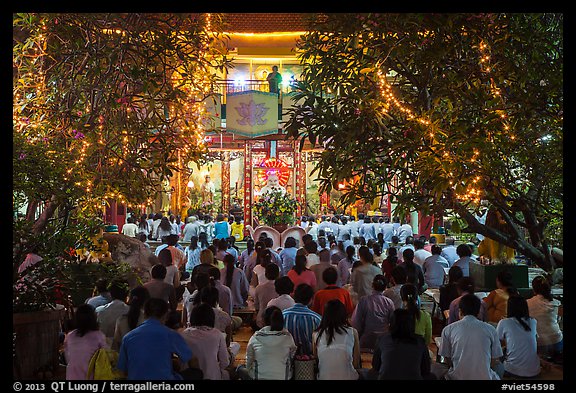 Worshippers at Quoc Tu Pagoda by night, district 10. Ho Chi Minh City, Vietnam (color)