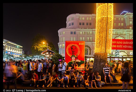 Revellers sitting on street, New Year eve. Ho Chi Minh City, Vietnam (color)
