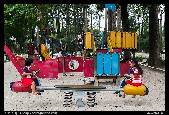 Girls with matching outfits on playground, Van Hoa Park. Ho Chi Minh City, Vietnam (color)