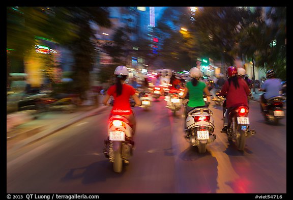 Blurry view from middle of street traffic at night. Ho Chi Minh City, Vietnam