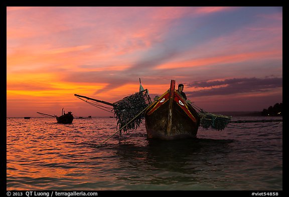 Man on fishing boat at sunset. Mui Ne, Vietnam