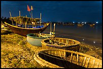 Coracle boats and fishing fleet at night. Mui Ne, Vietnam ( color)