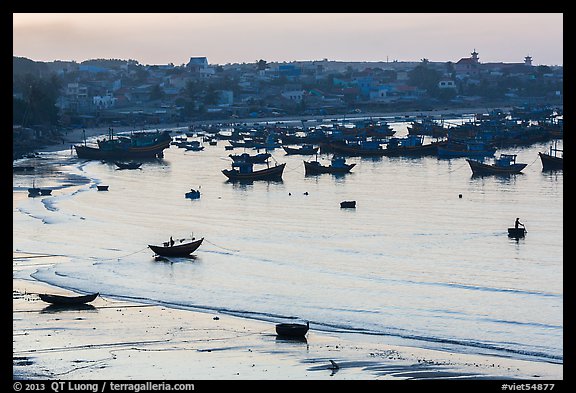 Fishing fleet and village at dawn. Mui Ne, Vietnam