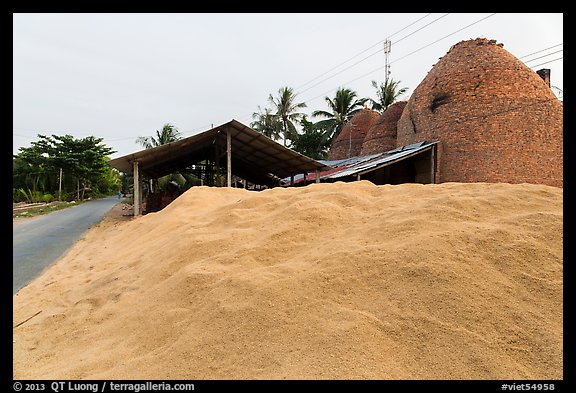 Pile of rice hulls near brick ovens. Mekong Delta, Vietnam