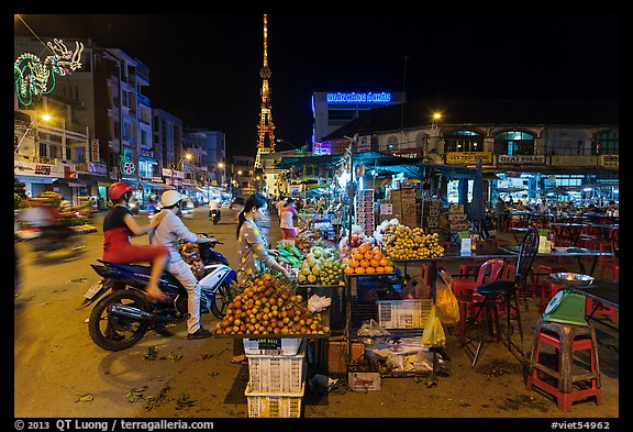 Street market and telecomunication tower at night. Tra Vinh, Vietnam (color)