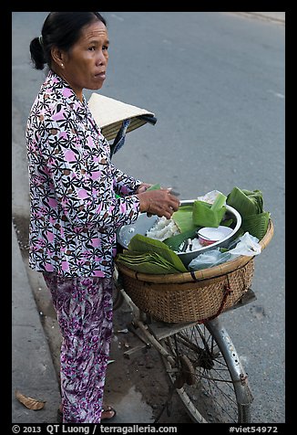 Woman vending food out of bicycle. Tra Vinh, Vietnam