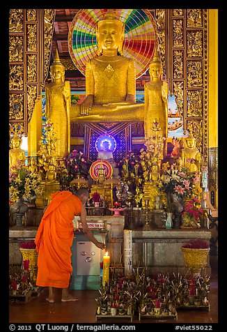 Monk lighting incense at  Ang Pagoda altar. Tra Vinh, Vietnam