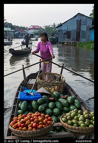 Woman paddles boat loaded with fruits and vegetable, Phung Diem. Can Tho, Vietnam (color)