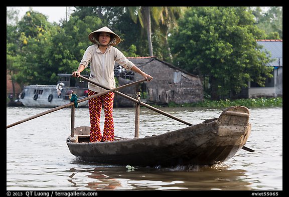 Woman using the distinctive x-shape paddle. Can Tho, Vietnam