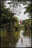 Woman walking across monkey bridge. Can Tho, Vietnam (color)