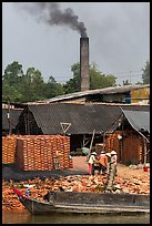 Workers moving bricks in brick factory. Sa Dec, Vietnam ( color)