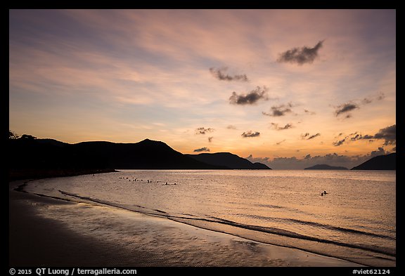Con Son Beach with people in water before sunrise. Con Dao Islands, Vietnam (color)