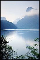 Morning mist on the tall cliffs surrounding Ba Be Lake. Northeast Vietnam ( color)