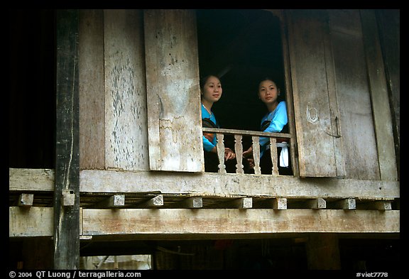 Two thai women at the window of their stilt house, Ban Lac village. Northwest Vietnam (color)