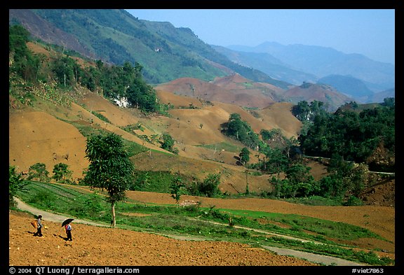 Two montagnards walking down a field, between Tuan Giao and Lai Chau. Northwest Vietnam (color)