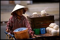 Coconut street vendor. The sweet juice is drank directly from a straw.. Ho Chi Minh City, Vietnam (color)