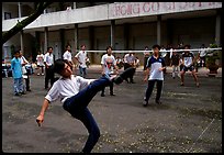 Students playing foot-only volley-ball in a school courtyard. Ho Chi Minh City, Vietnam (color)