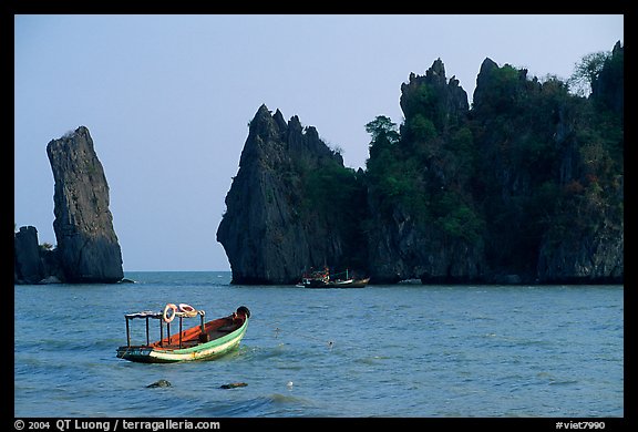 Small boats and offshore rock formations. Hong Chong Peninsula, Vietnam (color)