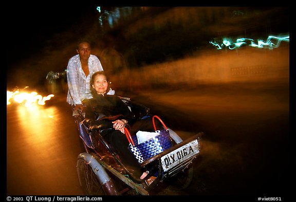 Enjoying the freshness of the night during a cyclo ride. Ho Chi Minh City, Vietnam (color)