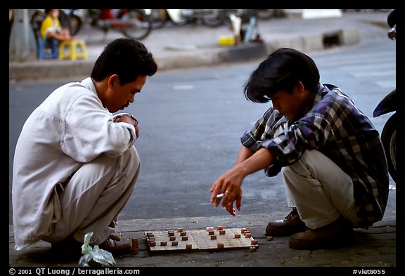 Chinese Chess game. Vietnamese people can sit on their heels for hours. Ho Chi Minh City, Vietnam (color)