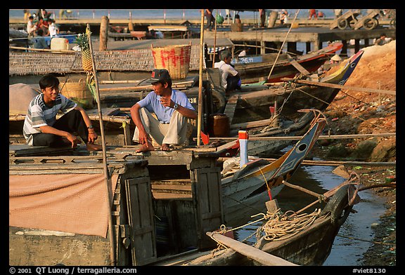 Boats from the delta waterways meet the sea. The pinapple on the pole serves to signal the boat cargo to others. Ha Tien, Vietnam (color)