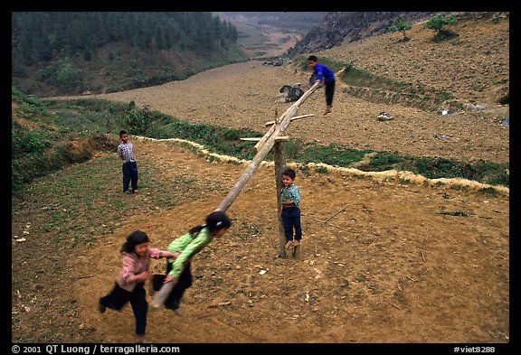 Children playing a rotating swing near Can Cau. Vietnam (color)