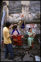 Hairdressing in the street. Ho Chi Minh City, Vietnam (color)