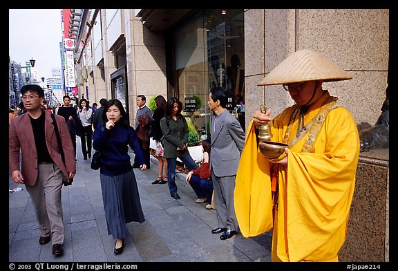Buddhist monk seeking alms in front of a Ginza department store. Tokyo, Japan (color)