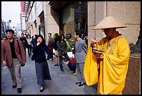 Buddhist monk seeking alms in front of a Ginza department store. Tokyo, Japan