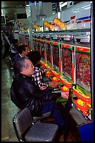 Playing a gambling maching. Tokyo, Japan ( color)