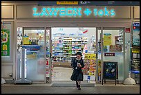 Girl in school uniform walking out of convenience store. Tokyo, Japan ( color)
