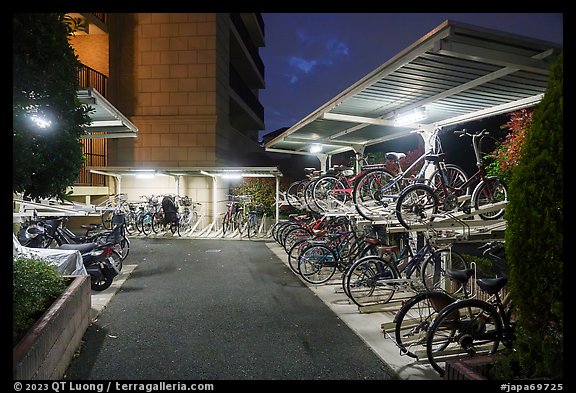 Stacked bicycle storage near residence at night, Yokohama. Japan (color)