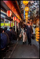 Couple walking in Omoide Yokocho, Shinjuku. Tokyo, Japan ( color)