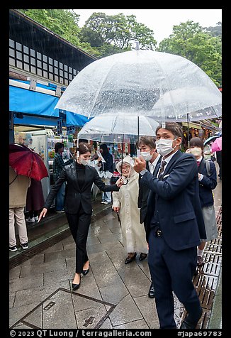 Visitors with umbrellas. Enoshima Island, Japan