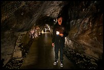 Boy with candle in first Enoshima Iwaya Cave. Enoshima Island, Japan ( color)