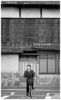 Bicyclist in front of a traditional style house. Kyoto, Japan ( black and white)