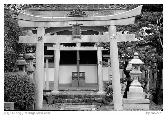 Tori gate at the entrance of a shrine inner grounds. The act of passing through purifies the soul.. Kyoto, Japan