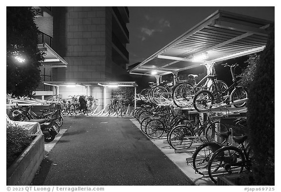 Stacked bicycle storage near residence at night, Yokohama. Japan (black and white)