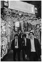 Men in suits at Omoide Yokocho at night, Shinjuku. Tokyo, Japan ( black and white)