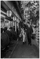 Couple walking in Omoide Yokocho, Shinjuku. Tokyo, Japan ( black and white)