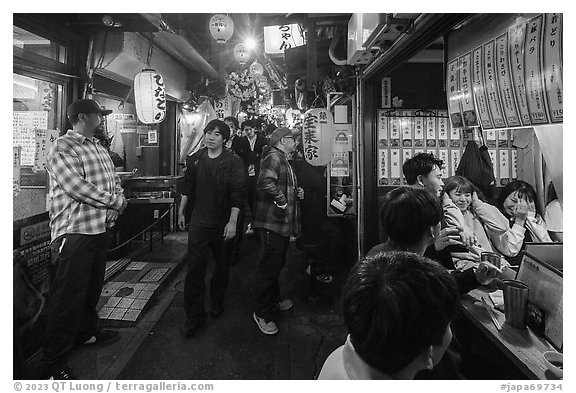 Crowded alley lined up with bars and restaurants, Omoide Yokocho, Shinjuku. Tokyo, Japan (black and white)