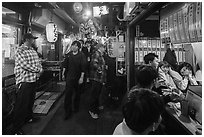 Crowded alley lined up with bars and restaurants, Omoide Yokocho, Shinjuku. Tokyo, Japan ( black and white)