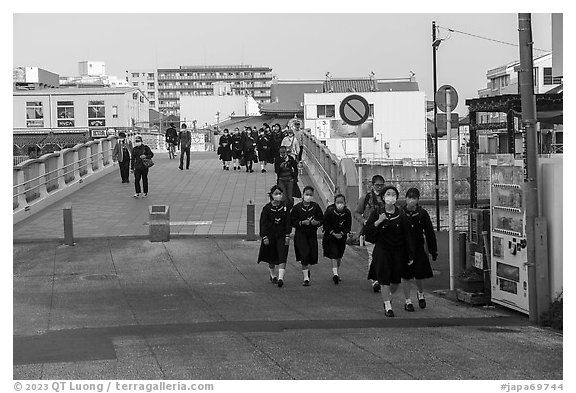 Schoolchildren walk over the Benten Bridge. Fujisawa, Japan (black and white)