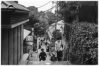 Couple on back street with restaurants. Enoshima Island, Japan ( black and white)