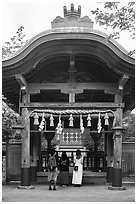 Women worshiping at Okutsumiya, the original shrine of the island. Enoshima Island, Japan ( black and white)